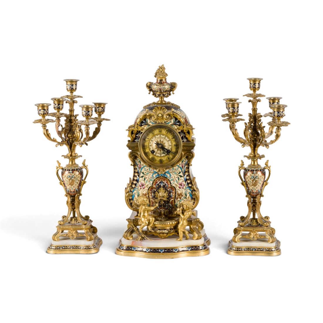 | HISTORISMUS-KAMINUHR MIT GIRANDOLEN: FIREPLACE CLOCK WITH GIRANDOLS France, Paris, Samuel Marti & Cie, circa 1890 Bronze, gilt, marble, enamel, glass, steel. Clock 45 x 22 x 15 cm, candlestick 41.5 x 12.5 x 12.5 cm. Movement marked 'S. M