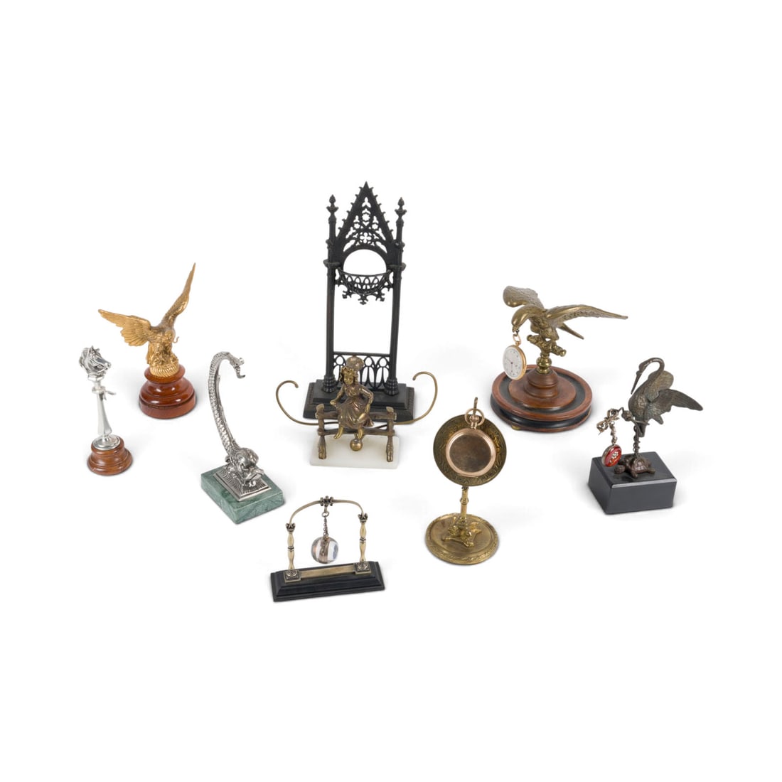 | KONVOLUT AUS 9 TASCHENUHRSTAeNDERN UND 4 TASCHENUHREN: LOT OF 9 POCKET WATCH STANDS AND 4 POCKET WATCHES 19th and 20th Centuries Iron (blackened), wood, bronze, metal, stone. Max. 30 x 14 x 6.5 cm; min. 11.5 x 11 x 4 cm. Partially rubbed, chipped, and dam