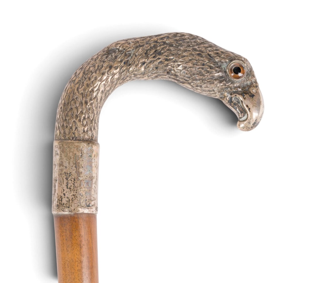 | FUeNF SPAZIERSTOeCKE: FIVE WALKING STICKS Late 19th/early 20th century Wood, metal (partially silver-plated), glass, horn. Total length 89-98.5 cm. Figural handles shaped as a bird's head, a hunting dog, a head in the styl
