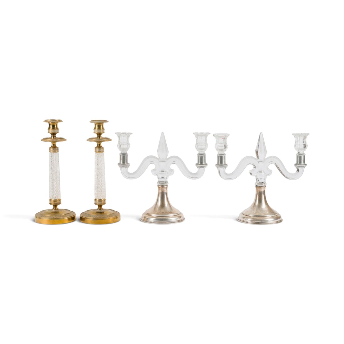 | ZWEI PAAR TAFELLEUCHTER: TWO PAIRS OF TABLE CANDLESTICKS Likely France (in part), possibly Baccarat, 20th century. Polished brass, crystal glass, and sterling silver, clear glass, pewter. 29.5 x 11.5 x 11.5 cm / 25.5 x 27 x 1