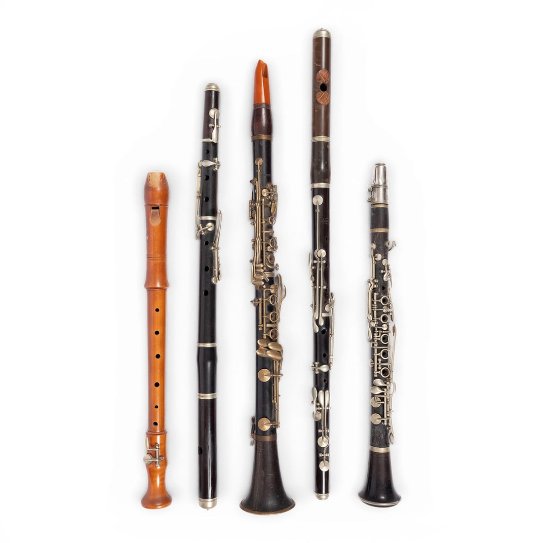 | KONVOLUT VON FUeNF HOLZBLASINSTRUMENTEN: SET OF FIVE WOODWIND INSTRUMENTS Europe, 19th/20th century Wood, metal keys. Height ranging from 48 to 69 cm. One transverse flute marked ''G. H. Hoeller, Schoeneck''; one historical clarinet marked '