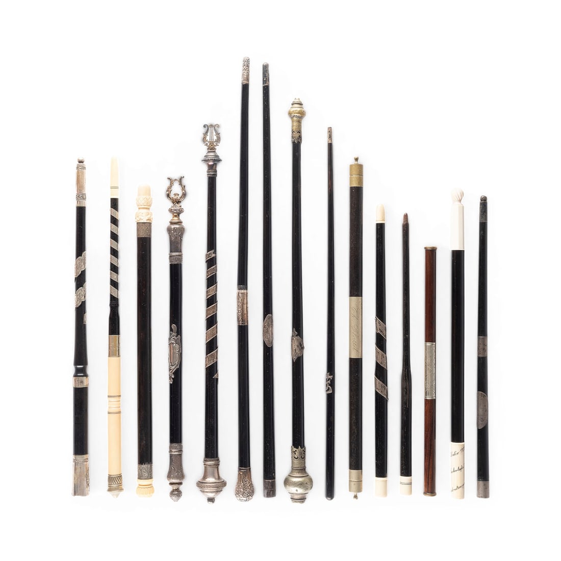 | KONVOLUT VON 15 DIRIGENTENSTAeBEN: COLLECTION OF 15 CONDUCTOR'S BATONS Germany, England, 19th/20th centuries Wood, lacquered black, some with silver mountings, 2 ivory tips. Lengths ranging from 35 to 51 cm. Some are marked, inscribed,