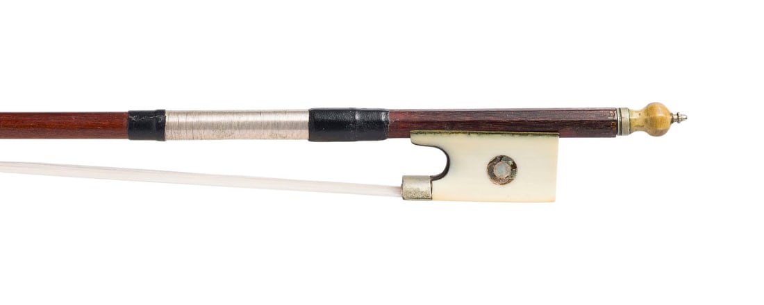 | VIOLINBOGEN: VIOLIN BOW German, early 20th century. Round shaft, Parisian eye, winding, thumb leather, ivory end plate and frog. Length 75, weight approx. 56 g. Violin bow unmarked. Part. bumped. CITES marketing c