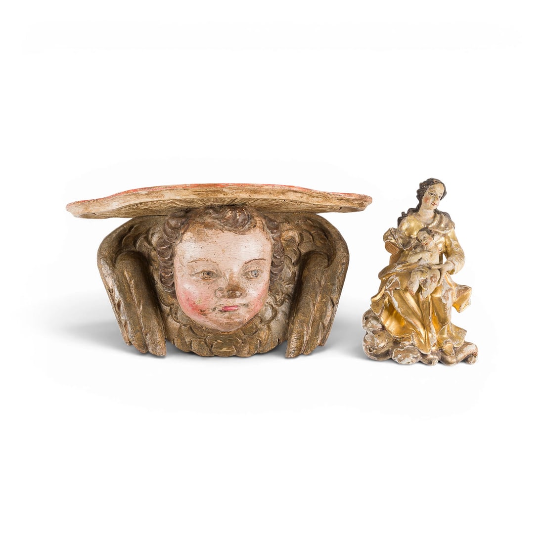 | GOTTESMUTTER MIT CHRISTUSKIND UND WANKONSOLE MIT GEFLUeGELTEM PUTTENKOPF: VIRGIN AND CHILD AND WALL BRACKET WITH WINGED PUTTO HEAD Wood, carved in the round, polychromed and gilded, flattened at the back. H. 16/14, W. 27/11, D. 5/13 cm. Minor chips and damage; losses to the