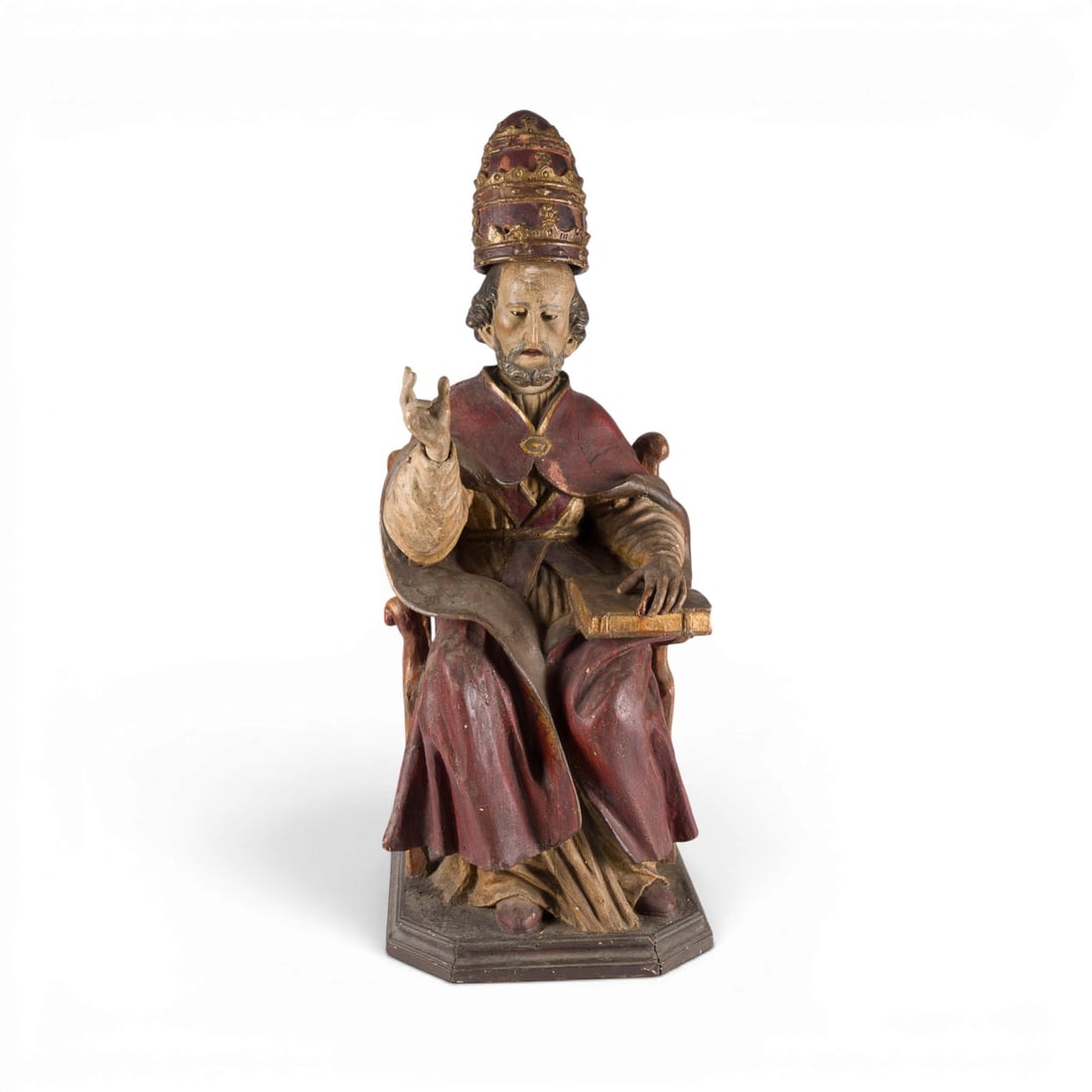 | SITZENDER HEILIGER PAPST (GREGOR DER GROSSE ODER SILVESTER): SEATED SAINT POPE (GREGORY THE GREAT OR SYLVESTER) Southern Germany, likely 16th century Wood, carved in the round, polychromed and partially gilded. H. 100, W. 43, D. 42 cm. A saintly pope seated on 