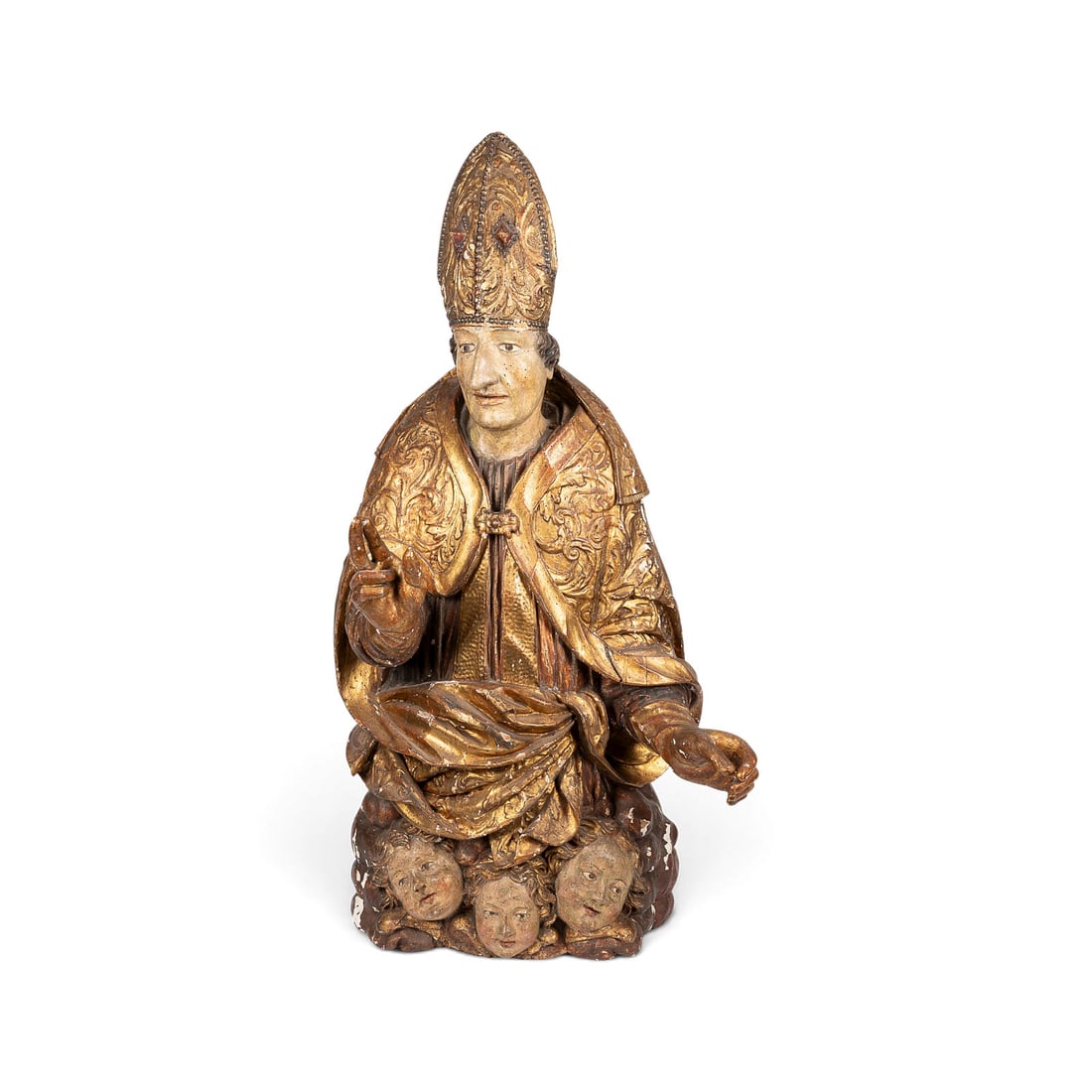 | GROSSER HALBFIGURIGER SEGNENDER BISCHOF AUF ENGELSGLORIE: LARGE HALF-LENGTH FIGURE OF A BLESSING BISHOP ON A GLORY OF ANGELS South German or Austrian, c. 1680-1700 Limewood, carved in the round, gesso ground, polychromed and gilded; flattened and hollowed ou