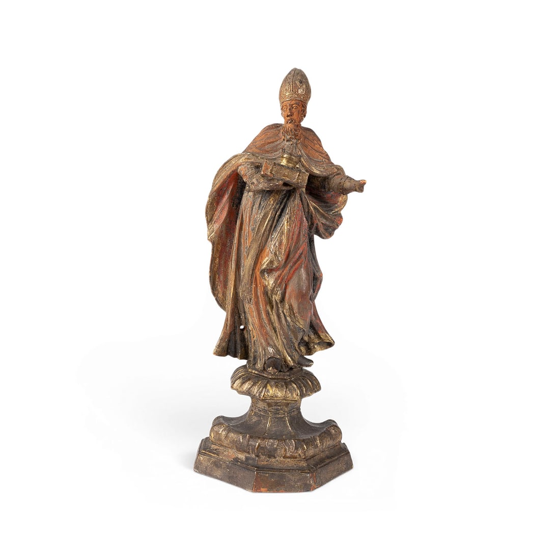 | HEILIGER BISCHOF MIT BUCH UND KRONE: SAINTLY BISHOP WITH BOOK AND CROWN German, 18th century Limewood, carved in the round, polychromed and gilded, on an ornate base. H. 32.5, W. 12.5, D. 8.5 cm. Minor chips and losses to the finish; fin