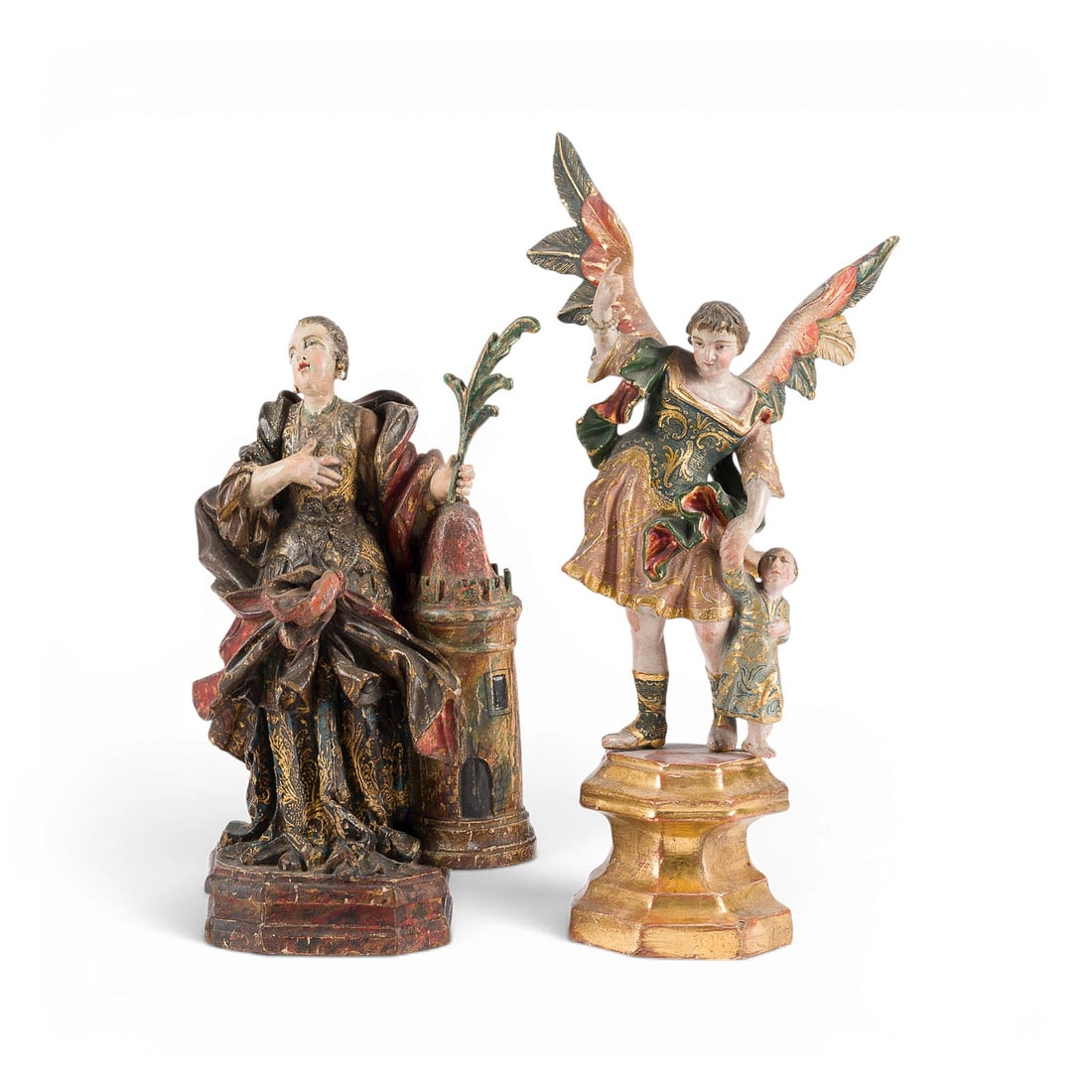 | ZWEI SAKRALE FIGUREN: ERZENGEL RAPHAEL UND HEILIGE BARBARA MIT TURM: TWO SACRED FIGURES: ARCHANGEL RAPHAEL AND SAINT BARBARA WITH TOWER South German, 18th century Lindenwood, carved in the round, polychromed and gilded, flattened at the back. H. 36/29, W. 18/16, D. 13/
