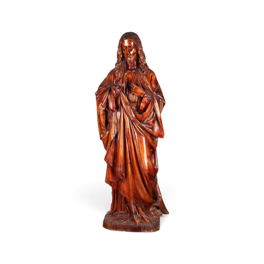 | MONUMENTALER SEGNENDER CHRISTUS: MONUMENTAL FIGURE OF CHRIST BLESSING Likely German, 18th century or earlier Linden wood, carved in the round; flattened and hollowed out at the back; mounted on a base. H. 168, W. 65, D. 50 cm. An imp