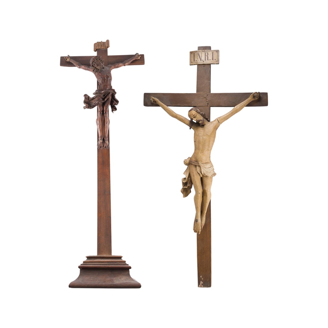 | ZWEI GROSSE KRUZIFIXE: TWO LARGE CRUCIFIXES German, 18th century Boxwood and linden wood, carved in the round, with partial polychrome finish; each with an INRI plaque. H. 130/126, W. 68/48, D. 15/16 cm. Minor chips and dam