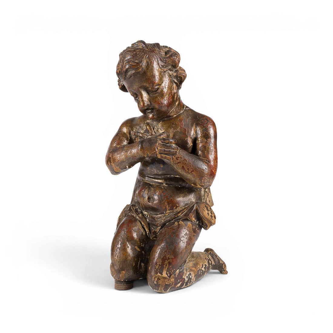 | KNIENDER ADORATIONSENGEL: KNEELING ANGEL IN ADORATION South German, circa 1700 Limewood, carved in the round, with traces of original polychrome finish; gessoed. H. 48, W. 24, D. 22 cm. Depiction of a kneeling angel in an atti
