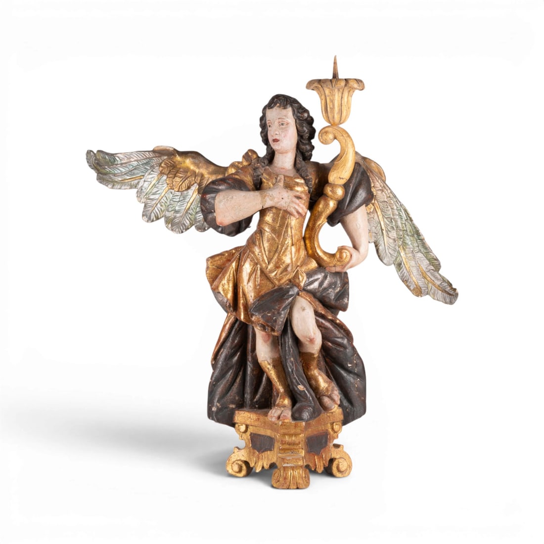 | GROSSER LEUCHTERENGEL: LARGE CANDLE-BEARING ANGEL Southern Germany or Austria, c. 1750 Wood, carved in the round, polychromed and gilded. H. 78, W. 80, D. 52 cm. Dynamically posed candle-bearing angel in a pronounced contra