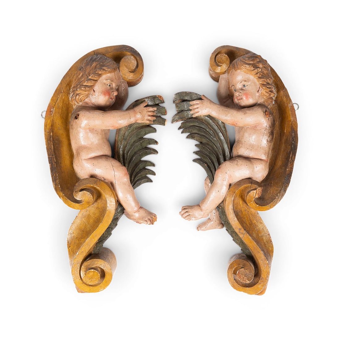 | PAAR SCHWEBENDE PUTTEN: PAIR OF FLOATING PUTTI South German, circa 1750 Wood, carved in the round, polychrome finish, flattened at the back. H. 68/67 cm each; W. 36/35 cm; D. 17/18 cm. A matching pair of putti executed as mi