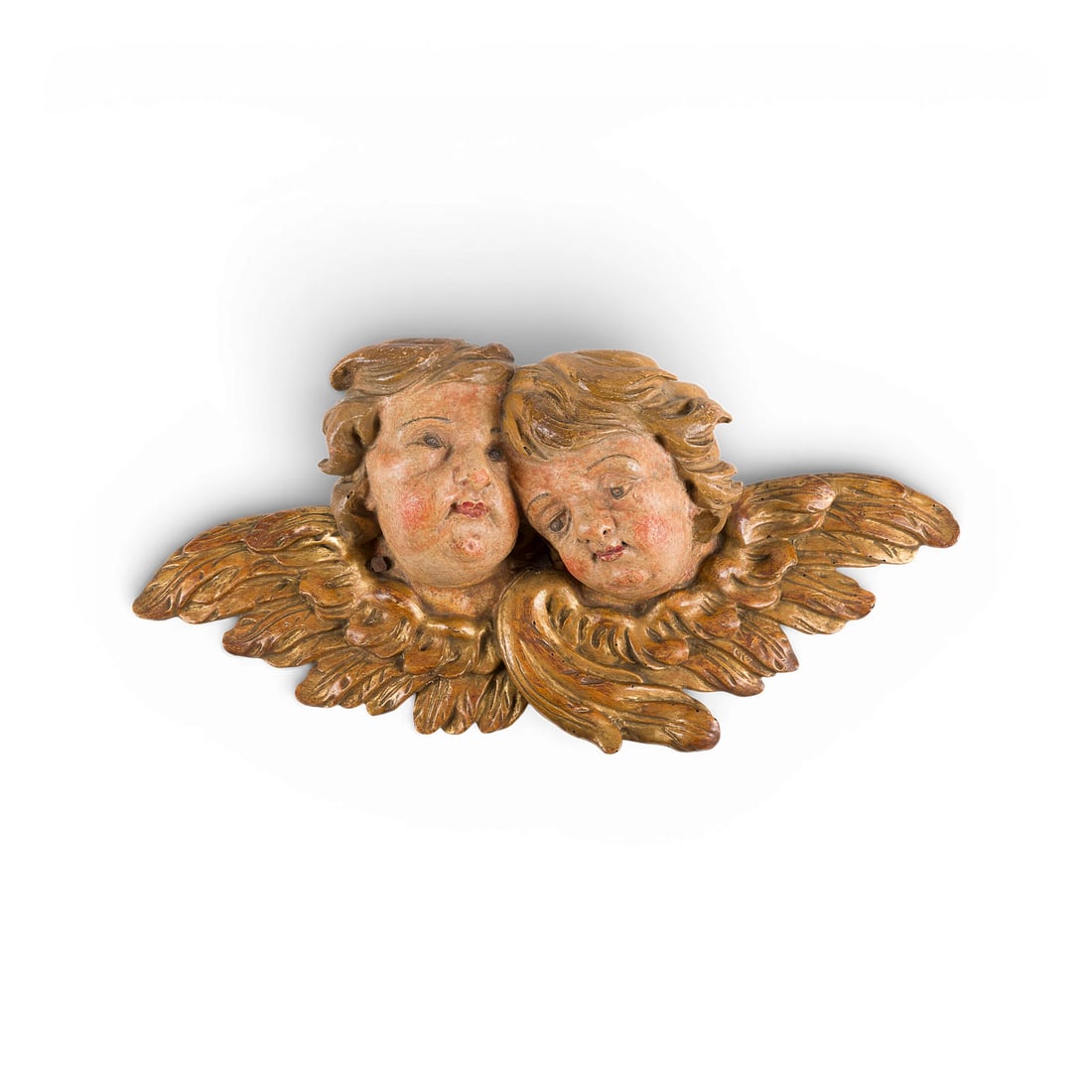 | PAAR GEFLUeGELTE PUTTENKOePFE: PAIR OF WINGED PUTTO HEADS South German or Austrian, 18th century Softwood, carved in high relief, polychrome and gilt finish, flattened at the back. H. 29, W. 53, D. 10 cm; weight approx. 1.79 kg. Mi
