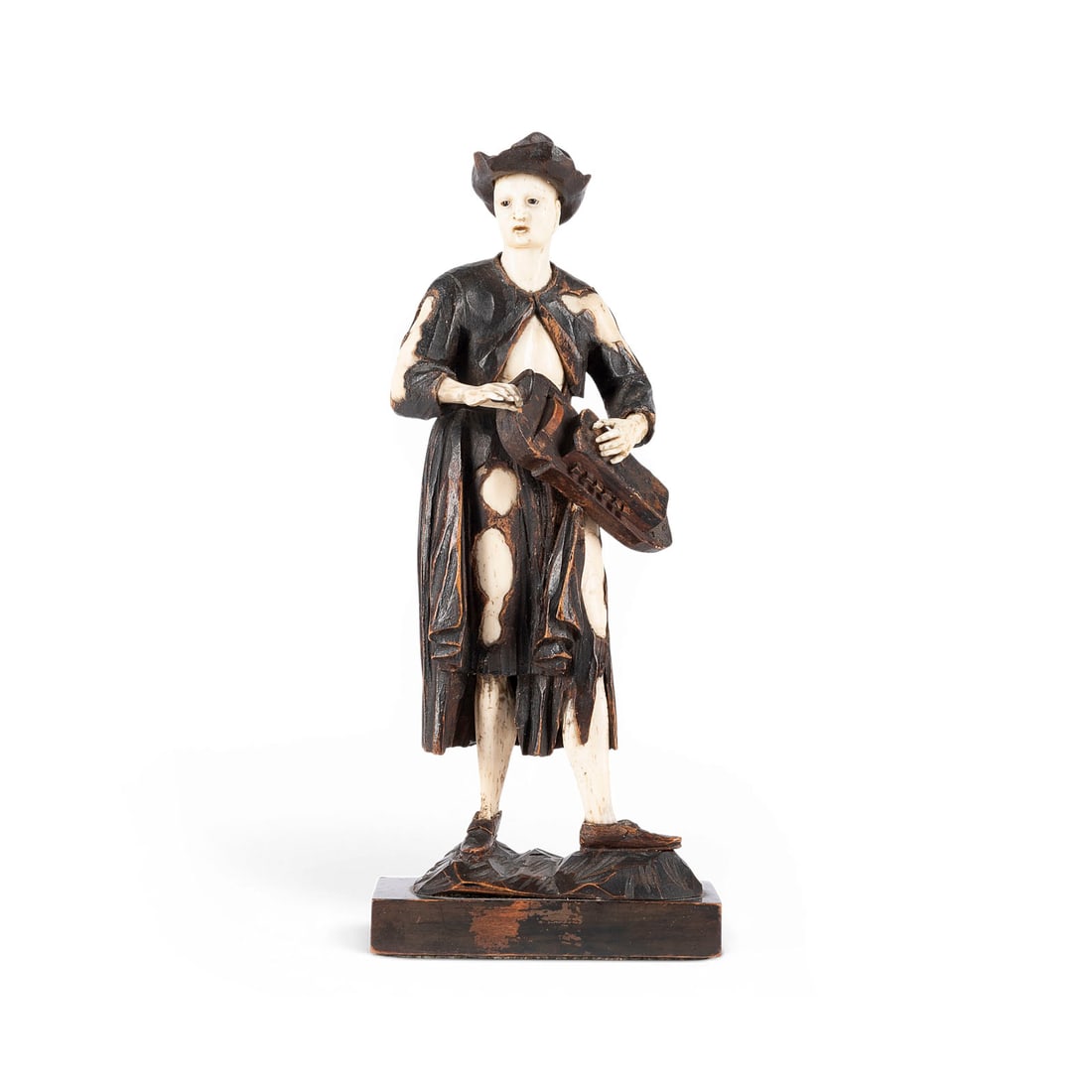 SIMON TROGER | STEHENDER DREHLEIERSPIELER: SIMON TROGER 1693-1769 (or circle of) STANDING HURDY-GURDY PLAYER Munich, c. 1700 or later Wood and bone, carved in the round, on a small base. H. 25, W. 10, D. 7 cm; weight approx. 240 g. Fully