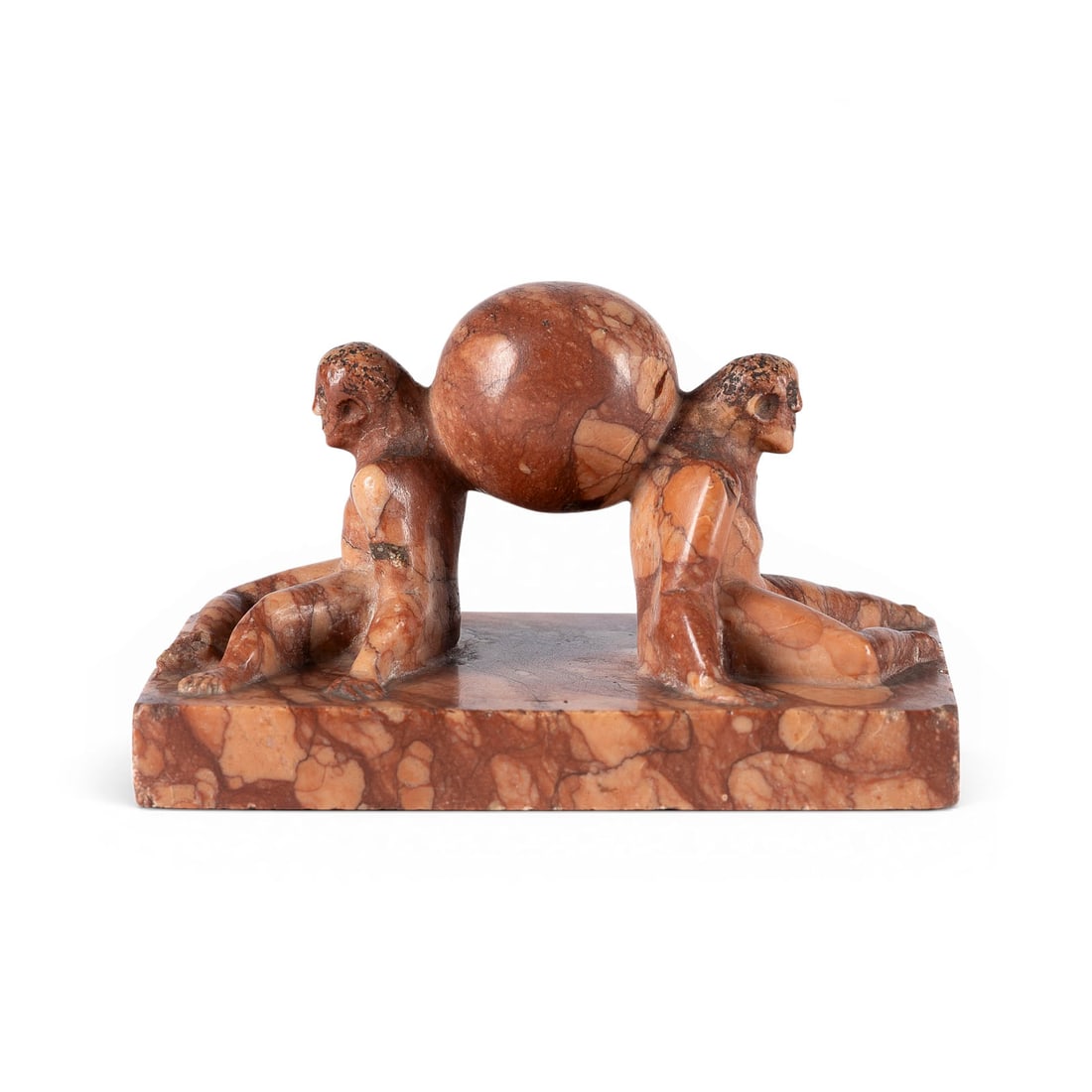 UNBEKANNTER BILDPLASTIKER | 'ZWEI ATHLETEN MIT KUGEL': UNKNOWN SCULPTOR Active early 20th century 'TWO ATHLETES WITH A SPHERE' Likely c. 1920-1930 Reddish-brown and white veined marble. H. 6.5, W. 10, D. 7.5 cm; weight approx. 0.39 kg. Small Art Deco scul
