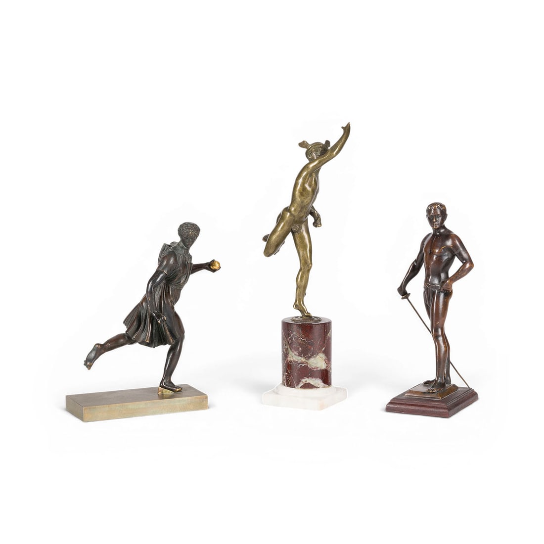 DIVERSE BILDPLASTIKER | KONVOLUT VON DREI BRONZEFIGUREN: VARIOUS SCULPTORS Active 19th/20th century GROUP OF THREE BRONZE FIGURES Bronze, with dark and light patination; each on a base of wood, bronze, or marble. Heights: 21 cm, 18 cm, 28 cm. Unsigned. A gr