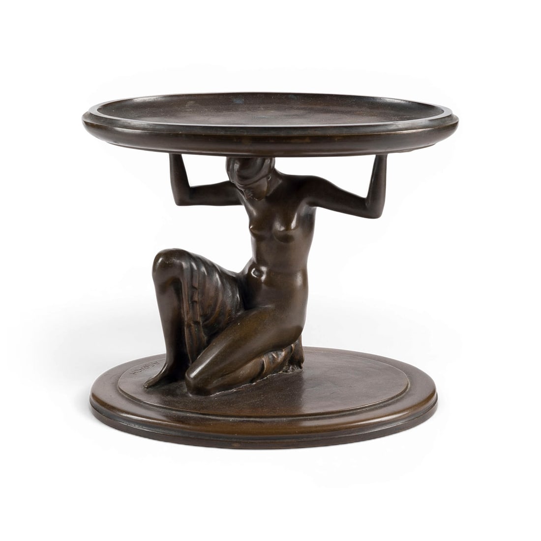 ANTON GRATH | FRAUENAKT ALS SCHALENTRAeGERIN: ANTON GRATH 1881 Vienna - 1956 Vienna FEMALE NUDE AS A BOWL BEARER Bronze, brown patina, on an oval plinth. H. 25, W. 28, D. 25 cm; weight approx. 6.94 kg. Signed 'A. Grath' on the plinth. Decorative 