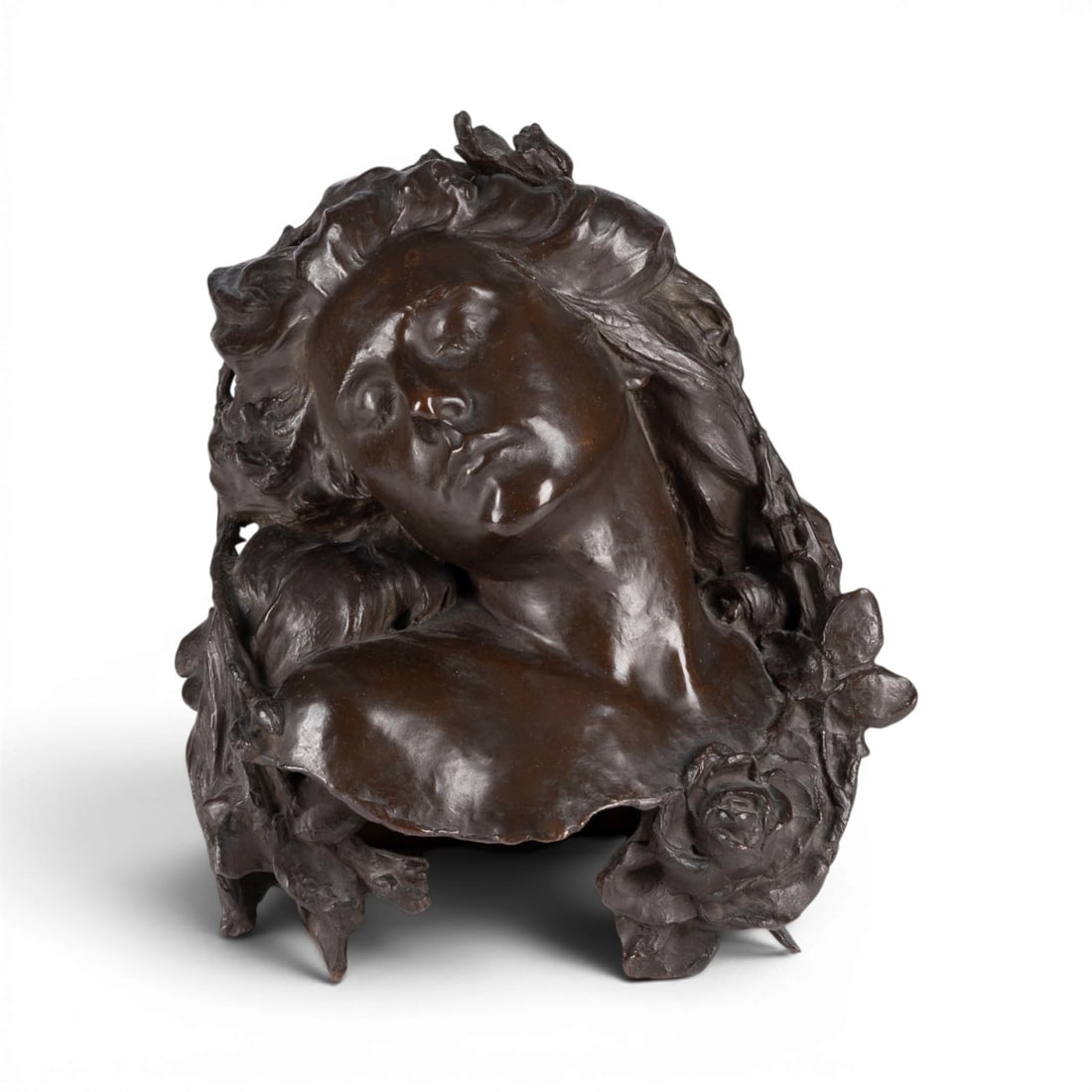 UNBEKANNTER BILDPLASTIKER | 'SLEEPING BEAUTY' ('DIE SCHLAFENDE'): UNKNOWN SCULPTOR Active early 20th century 'SLEEPING BEAUTY' Bronze, dark patina. H. 41, W. 34, D. 32 cm. Unsigned. Expressive bust of a young woman with closed eyes and head tilted slightly to the si