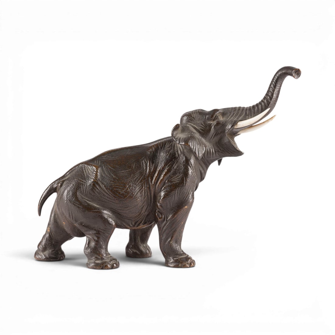 UNBEKANNTER BILDPLASTIKER | ELEFANT: UNKNOWN SCULPTOR Active early 20th century ELEPHANT Germany or Japan Bronze, dark patina; tusks carved from bone. H. 21, W. 27, D. 9 cm; weight approx. 2.89 kg. Unsigned; likely German or an export pi