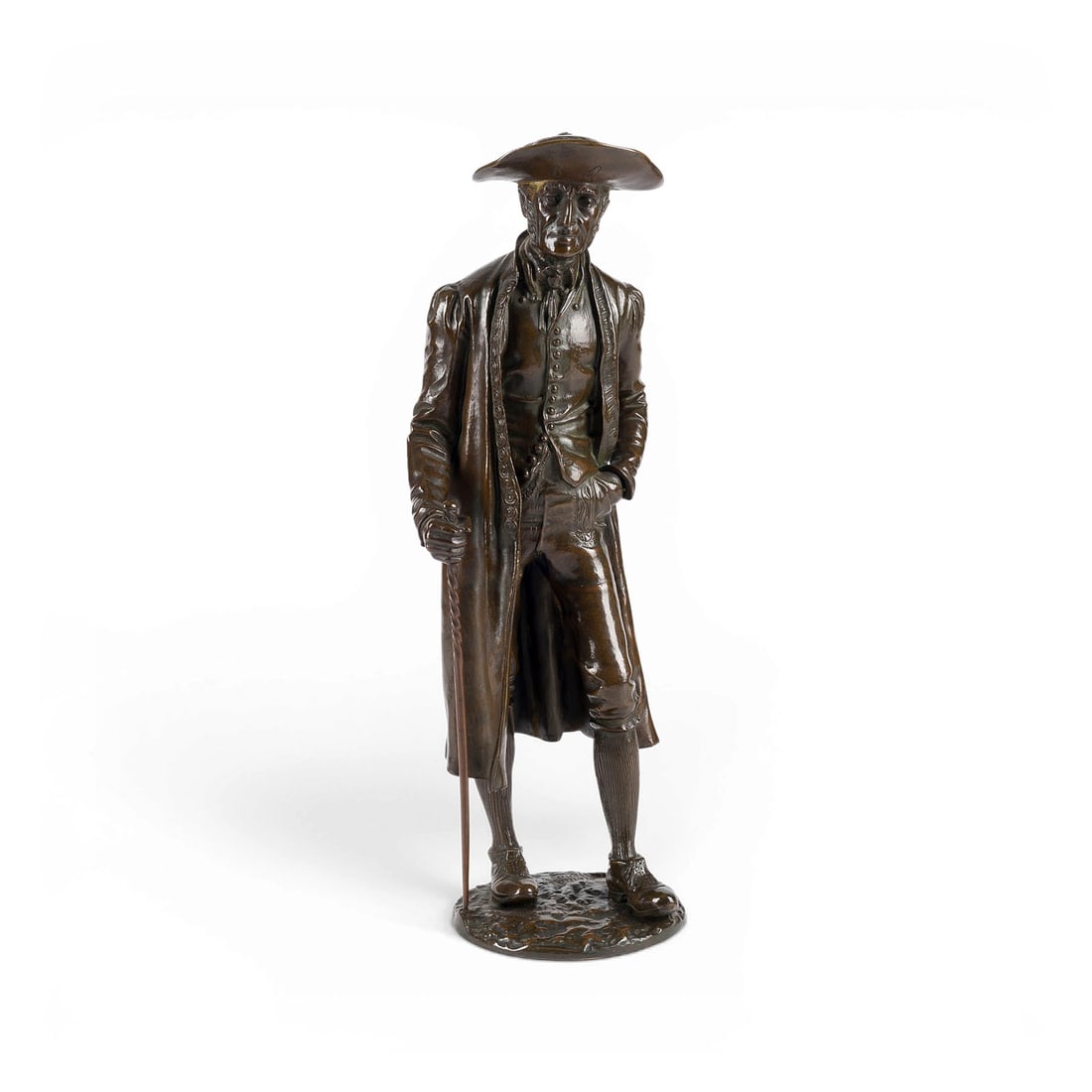 UNBEKANNTER BILDPLASTIKER 'FREMD?' | 'STEHENDER HERR IM DREISPITZ MIT GEHSTOCK': UNKNOWN SCULPTOR 'FREMD?' Active circa 1900 'STANDING GENTLEMAN IN TRICORNE HAT WITH WALKING STICK' Probably France, 1890 Bronze, brown patina, on a round plinth (H. 38.5, W. 14, D. 14.5 cm; weight ap