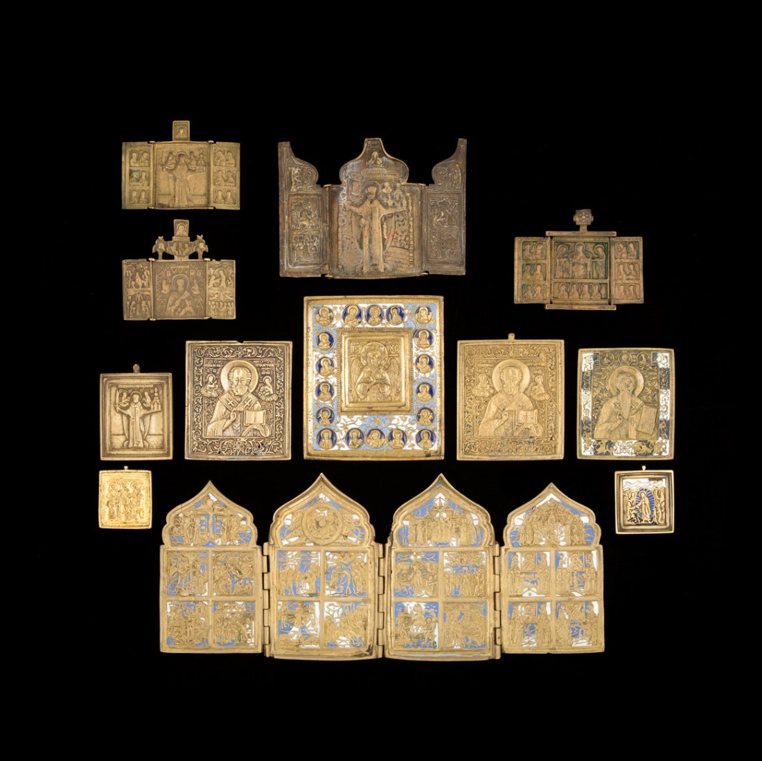 SAMMLUNG VON ZWÖLF BRONZEIKONEN: A COLLECTION OF TWELFE BRASS ICONS Russian, 19th/20th century Including a quadriptych with the Feasts, five icons showing St. Nicholas the Wonder Worker and an icon depicting Christ 'the Blessed Silen