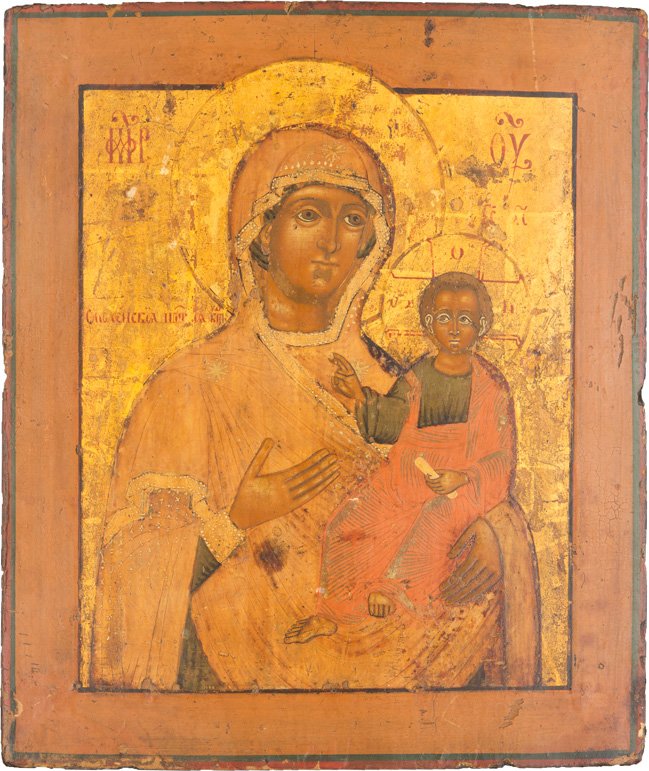 GOTTESMUTTER VON SMOLENSK (SMOLENSKAJA): THE SMOLENSKAYA MOTHER OF GOD Russian, 18th century Tempera on wood panel. Holding Christ in one hand and gesturing to him with the other, Christ blessing and clutching a small scroll. The faces of th