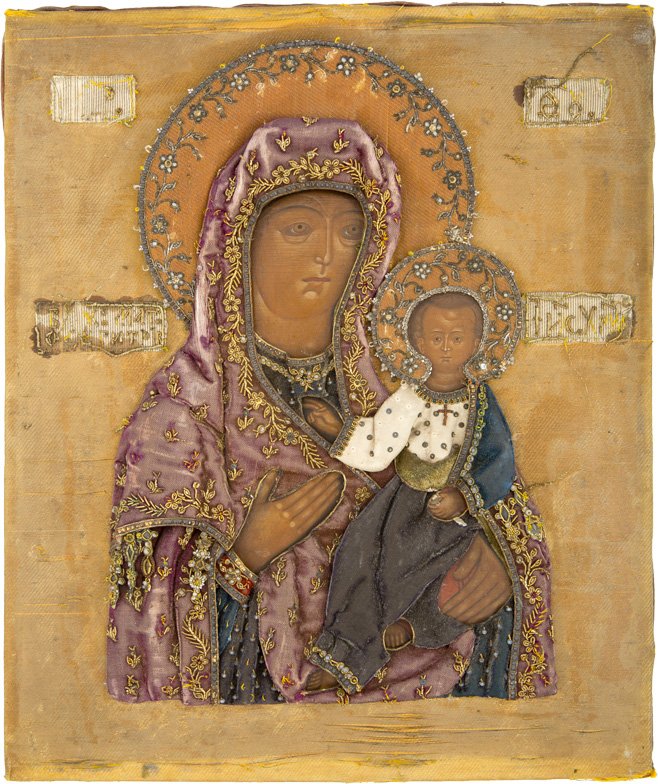 GOTTESMUTTER VON SMOLENSK (SMOLENSKAJA): THE SMOLENSKAYA MOTHER OF GOD Russian, 19th century Tempera on wood panel, with velvet backing. Traditionally painted. The garments composed of Russian pearl embroidery. Minimal missings. 31.2 x 26 cm