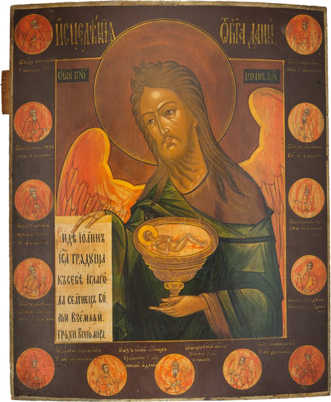 GROssFORMATIGE IKONE MIT JOHANNES DEM VORLÃ„UFER AUS: A LARGE ICON SHOWING ST. JOHN THE FORERUNNER FROM A DEISIS Russian, 19th century Tempera on wood panel. St. John portrayed half-length in three quarter view holding an open scroll and a chalice with t