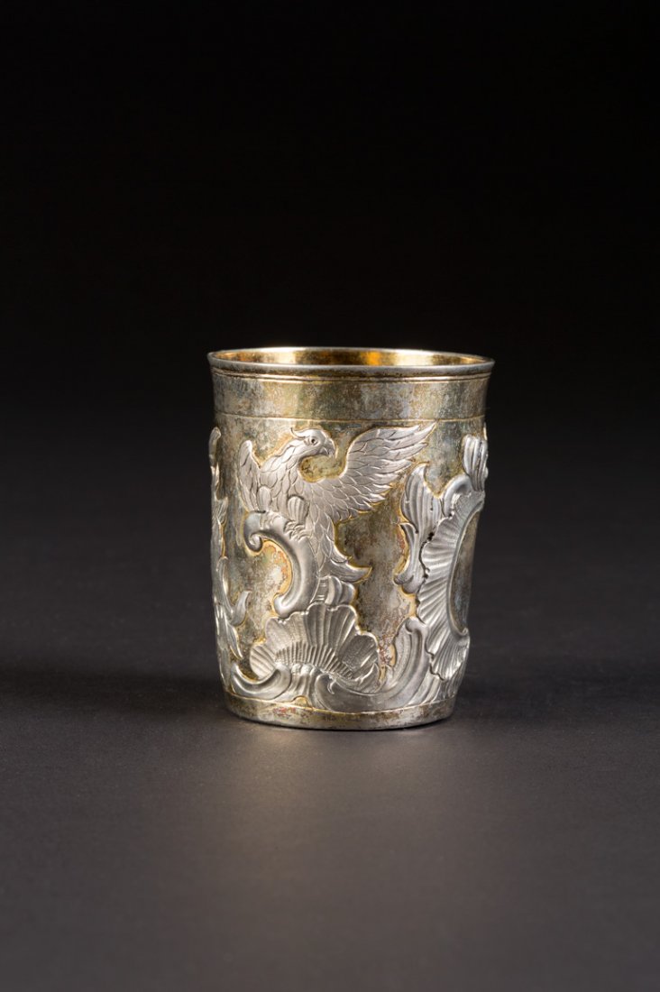 ROKOKO-BECHER: A SILVER BEAKER Russian, Moscow, Petr Fedorovitch Serebrenikov, 1763 Of cylindrical form, repoussÃ© and chased with rococo scrolls and eagles. Marked under base with city hallmark, assayer's mark, a
