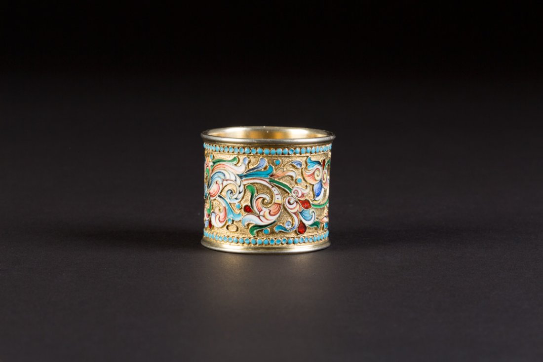 CLOISONNÃ‰-EMAIL-SERVIETTENRING: A SILVER-GILT AND CLOISONNÃ‰ ENAMEL NAPKIN HOLDER Russian, Moscow, 1896-1908 Of circular section. The surface decorated with polychrome floral and geometric ornament on stippled ground. Marked with