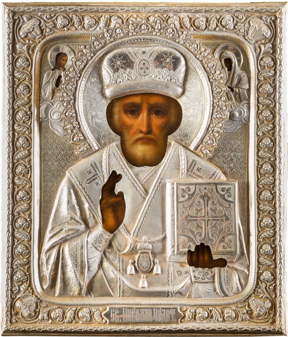 ST. NICHOLAS OF MYRA WITH OKLAD Russian, circa 1880 Oil: ST. NICHOLAS OF MYRA WITH OKLAD Russian, circa 1880 Oil on wood panel with velvet backing. Realistically painted. Overlaid with a chased and embossed silvered brass oklad. 31.5 x 26.6 cm. HEILIGER NIK