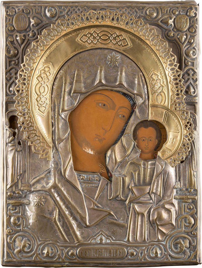 A LARGE ICON OF THE MOTHER OF GOD OF KAZAN WITH OKLAD: A LARGE ICON OF THE MOTHER OF GOD OF KAZAN WITH OKLAD Russian, circa 1870 Tempera on wood panel. Overlaid with a brass oklad. Two selected saints on the borders. Minimally worn. 38.5 x 29.7 cm. IKONE 