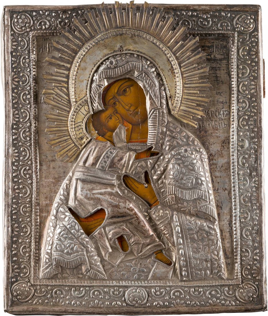AN ICON OF THE MOTHER OF GOD OF VLADIMIR WITH OKLAD: AN ICON OF THE MOTHER OF GOD OF VLADIMIR WITH OKLAD Russian, 2nd half 19th century Tempera on wood panel. Overlaid with a metal oklad chased and embossed with scrolling foliage. Minimal losses. 32 x 2