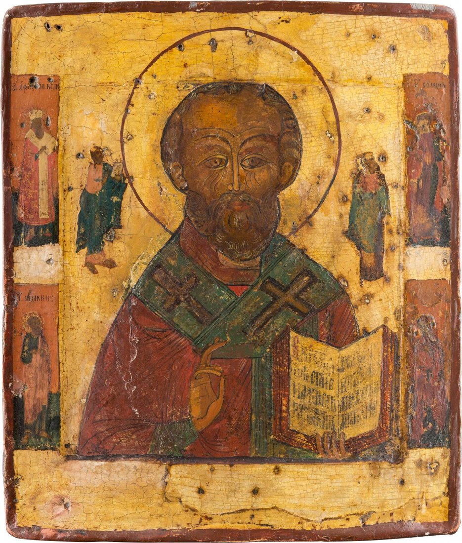 AN ICON SHOWING ST. NICHOLAS OF MYRA Russian, circa: AN ICON SHOWING ST. NICHOLAS OF MYRA Russian, circa 1800 Tempera on wood panel with double kovcheg. Four selected saints on the borders. The background and border stripped to gesso, restorations. 30.7