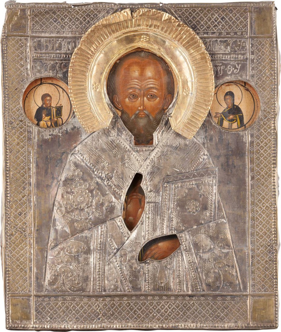 AN ICON SHOWING ST. NICHOLAS OF MYRA WITH OKLAD: AN ICON SHOWING ST. NICHOLAS OF MYRA WITH OKLAD Russian, mid 19th century Tempera on wood panel. Overlaid with a silvered brass oklad. Damages. 35.2 x 29.8 cm. Messingoklad. 35,2 x 29,8 cm. Oklad teil