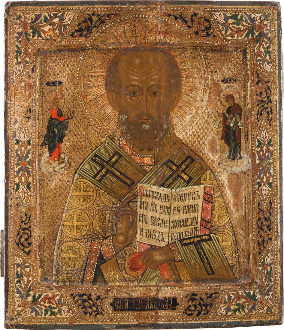 AN ICON SHOWING ST. NICHOLAS OF MYRA Russian, late 19th: AN ICON SHOWING ST. NICHOLAS OF MYRA Russian, late 19th century Tempera on wood panel with kovcheg. The background ornately incised and the border painted in faux enameling. Vertical crack restored, w