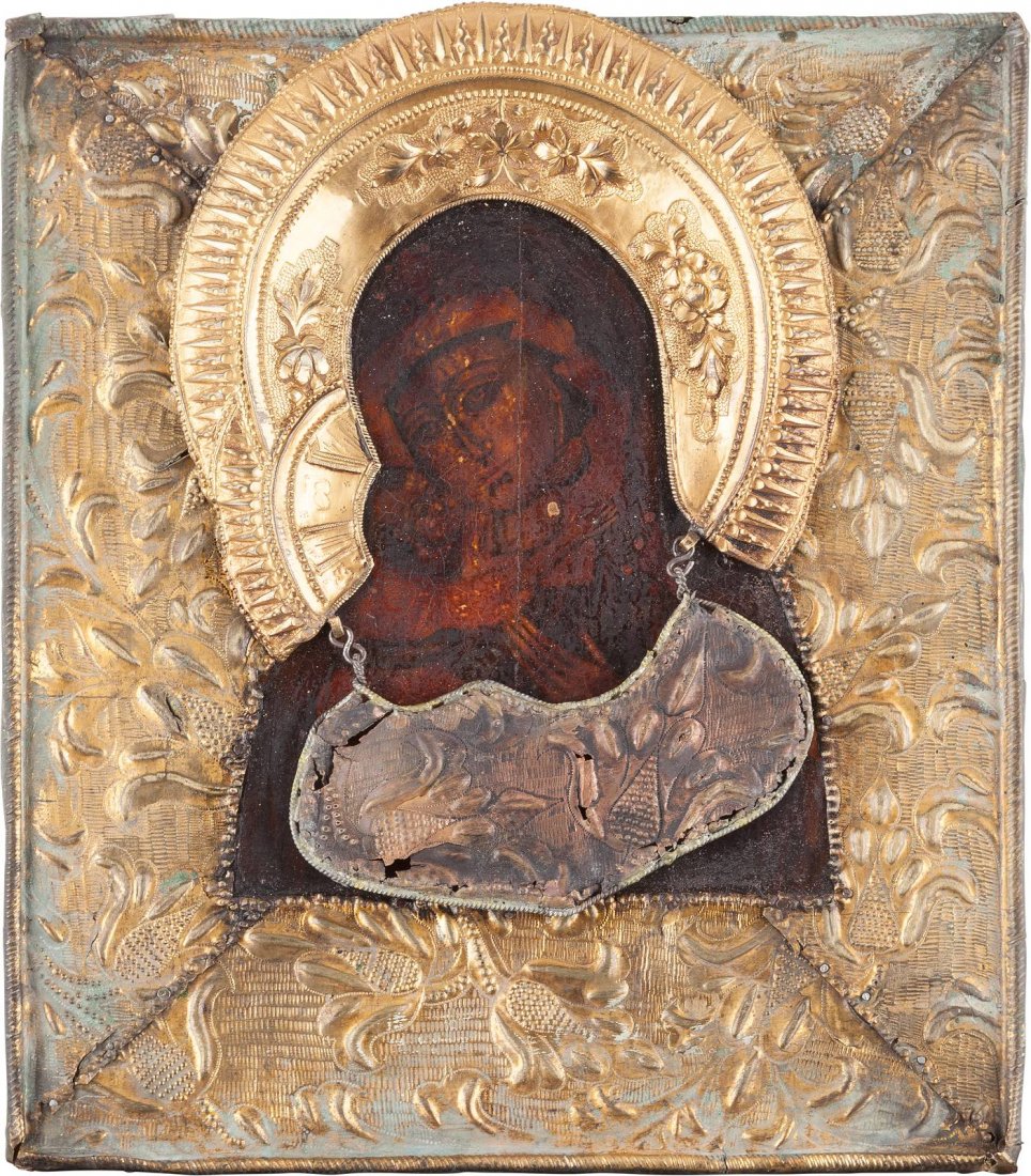 AN ICON SHOWING THE VLADIMIRSKAYA MOTHER OF GOD WITH: AN ICON SHOWING THE VLADIMIRSKAYA MOTHER OF GOD WITH RIZA Russian, circa 1800 Tempera on wood panel with velvet backing. Overlaid with a metal-gilt riza and tsata. Vertical crack, damages. 30 x 26 cm.