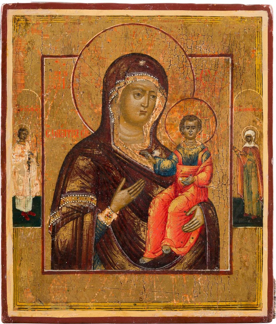 A SMALL ICON SHOWING THE SMOLENSKAYA MOTHER OF GOD: A SMALL ICON SHOWING THE SMOLENSKAYA MOTHER OF GOD Russian, 19th century Tempera on wood panel. Executed on a gold ground. Two selected saints on the borders including the Guardian Angel. Minimally wo
