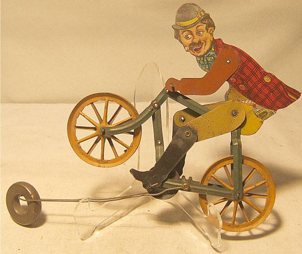 Charlie Chaplin Tin Litho Bicycle Rider, US 1920': Charlie Chaplin Tin Litho Bicycle Rider, US 1920's ( Usually Attributed to AC Gilbert Co. Unlicensed Chapli Toy Marketed as Slippery Slim), 8" long, Excellent Condition