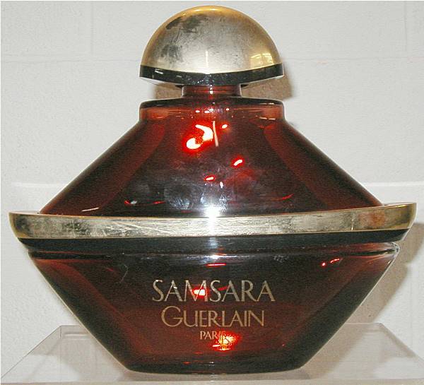 Samsara Guerlain, Paris Factice Dummy Bottle: Samsara Guerlain, Paris Factice Dummy Bottle, 11 1/2"W x 10 1/2"H x 3 1/4"D, Ruby Colored Bottle w/Gold Band Around Middle & Gold Stopper, Excellent Condition