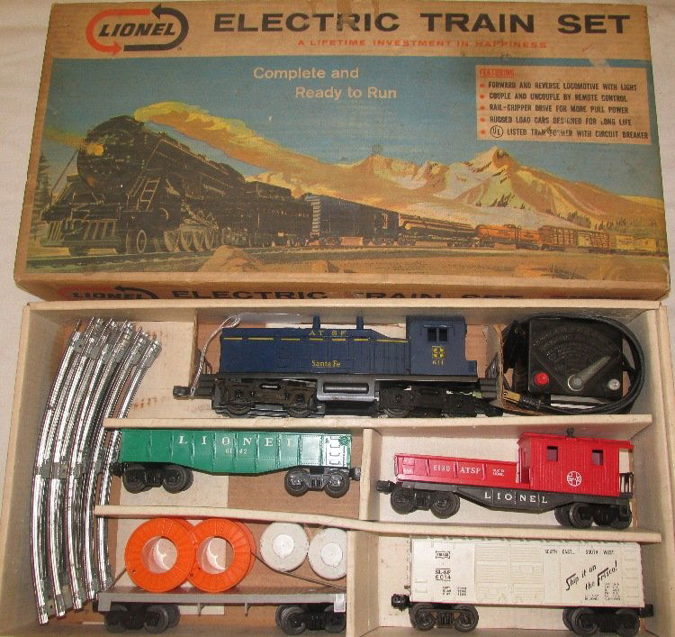 Lionel Train Set #11530 5 Unit Diesel Freight Set with: Complete set includes #634 Santa Fe Diesel Engine, #6142 Hopper, #6014 Box Car, Flat car with Load, and #6130 Working Caboose. Includes transformer, track, instructions, and original box. Nera Mint