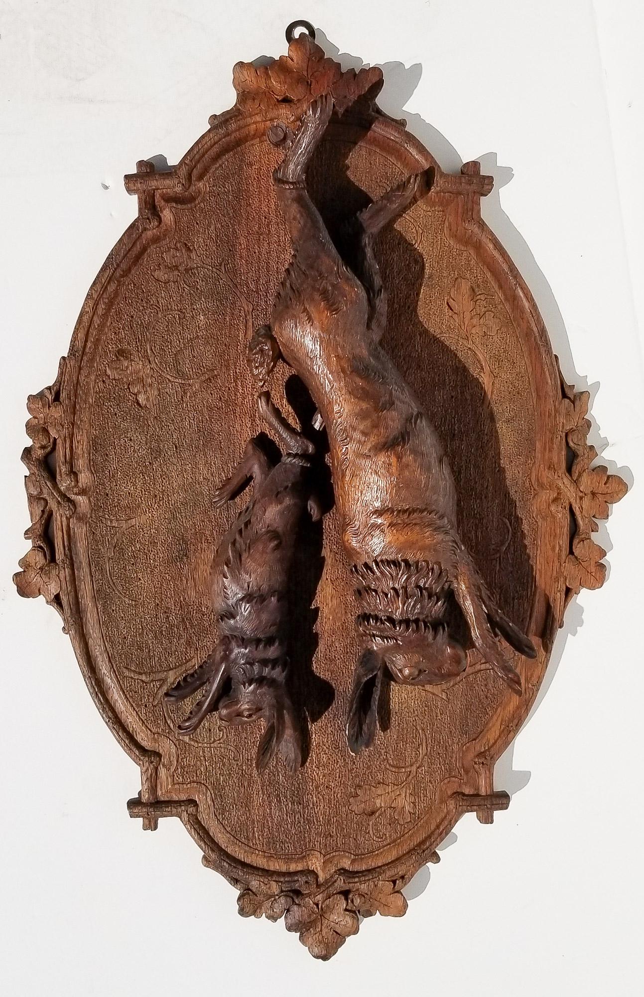 Black Forest Carving 12 of 20: Black Forest Carving 12 of 20, hare rabbit relief game hunt plaque, the smaller with glass eyes, 30 x 20 x 3 inches. Provenance: This German Austrian Swiss Bavarian Alpine figural carving is one of tw