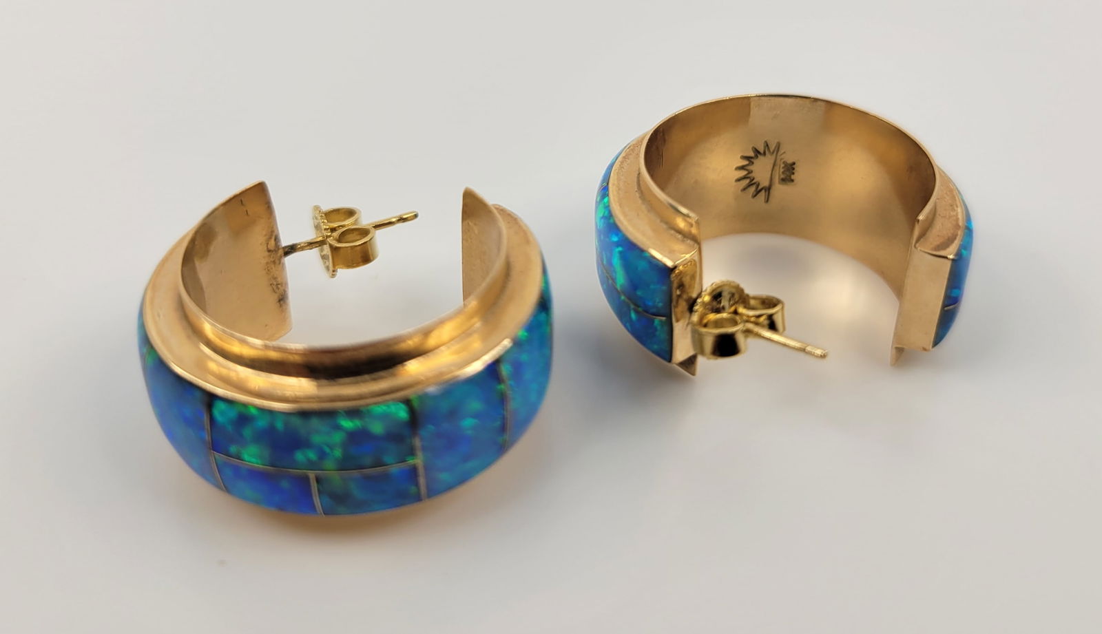 Irene Cara Estate Pair 14k Australian Opal Native American Gold Shop Mark Earrings COA: Irene Cara Estate pair 14k Australian opal Native American gold shop mark earrings COA. Each stamped with an unidentified rising sun shop mark and 14k, gold is a rich hue halfway to rose gold with an