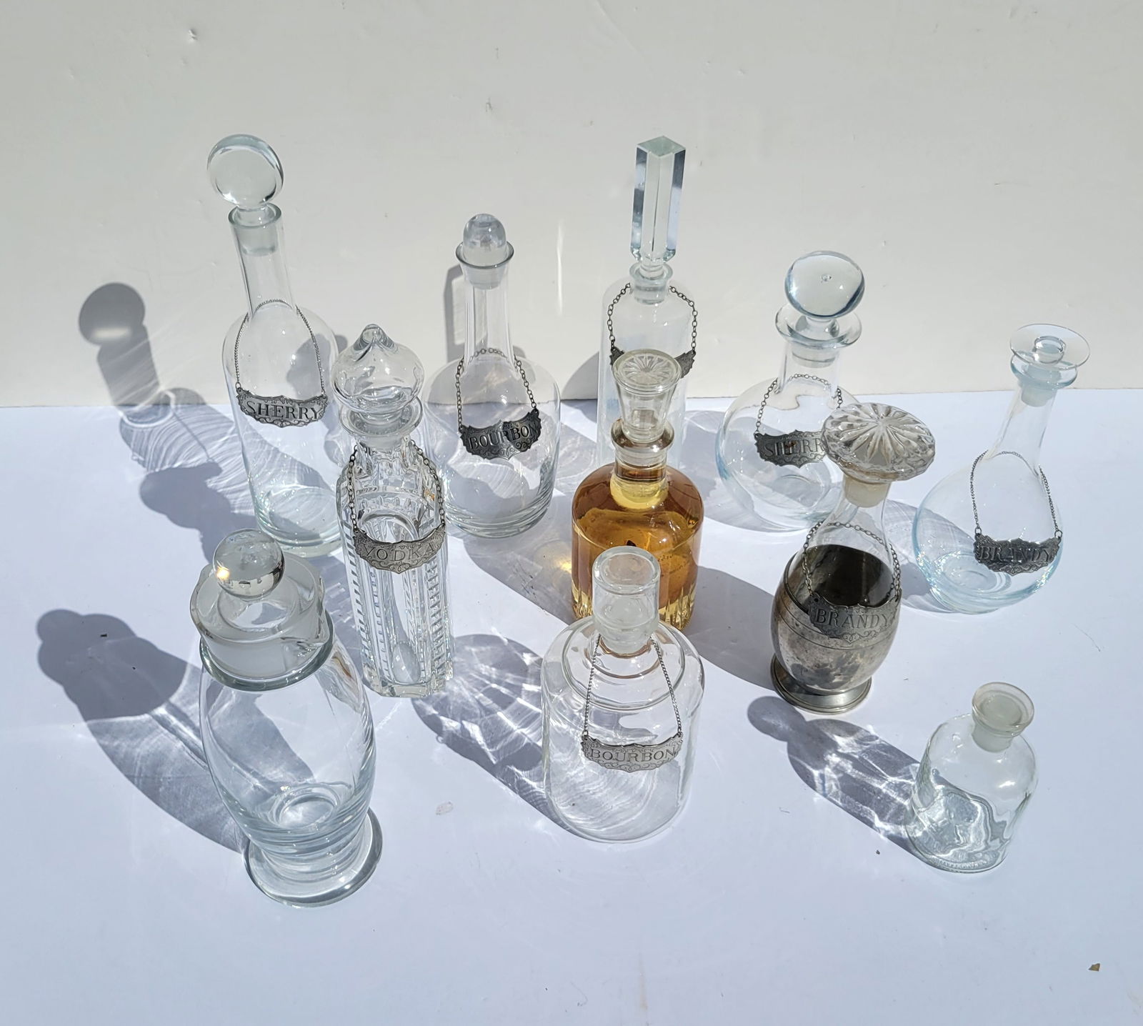 Lot 11 Glass Decanters Some With Pewter Steiff Bottle Tags (1 of 1)