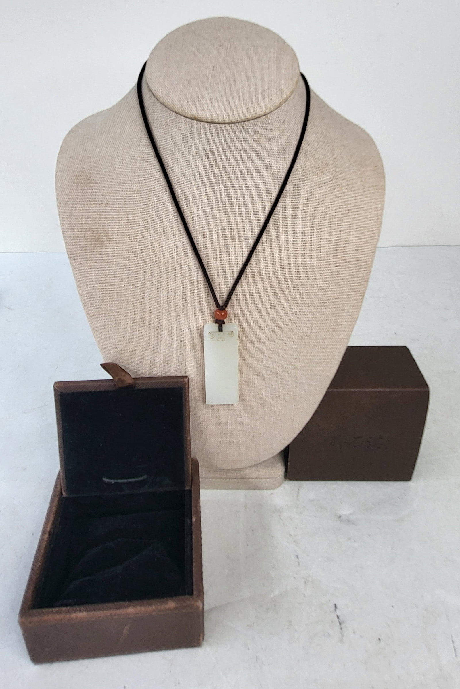 Carved Celadon Jade Pendant Amulet With Carnelian Bead Cord Necklace Jade Portion Aprx 9g 1.9 X 0.7: Carved Celadon Jade Pendant Amulet With Carnelian Bead Cord Necklace Jade Portion Aprx 9g 1.9 X 0.7 X 0.175 Inches Cord Tied At 16 Inches Boxed. See condition report for side polish note. Provenance: 