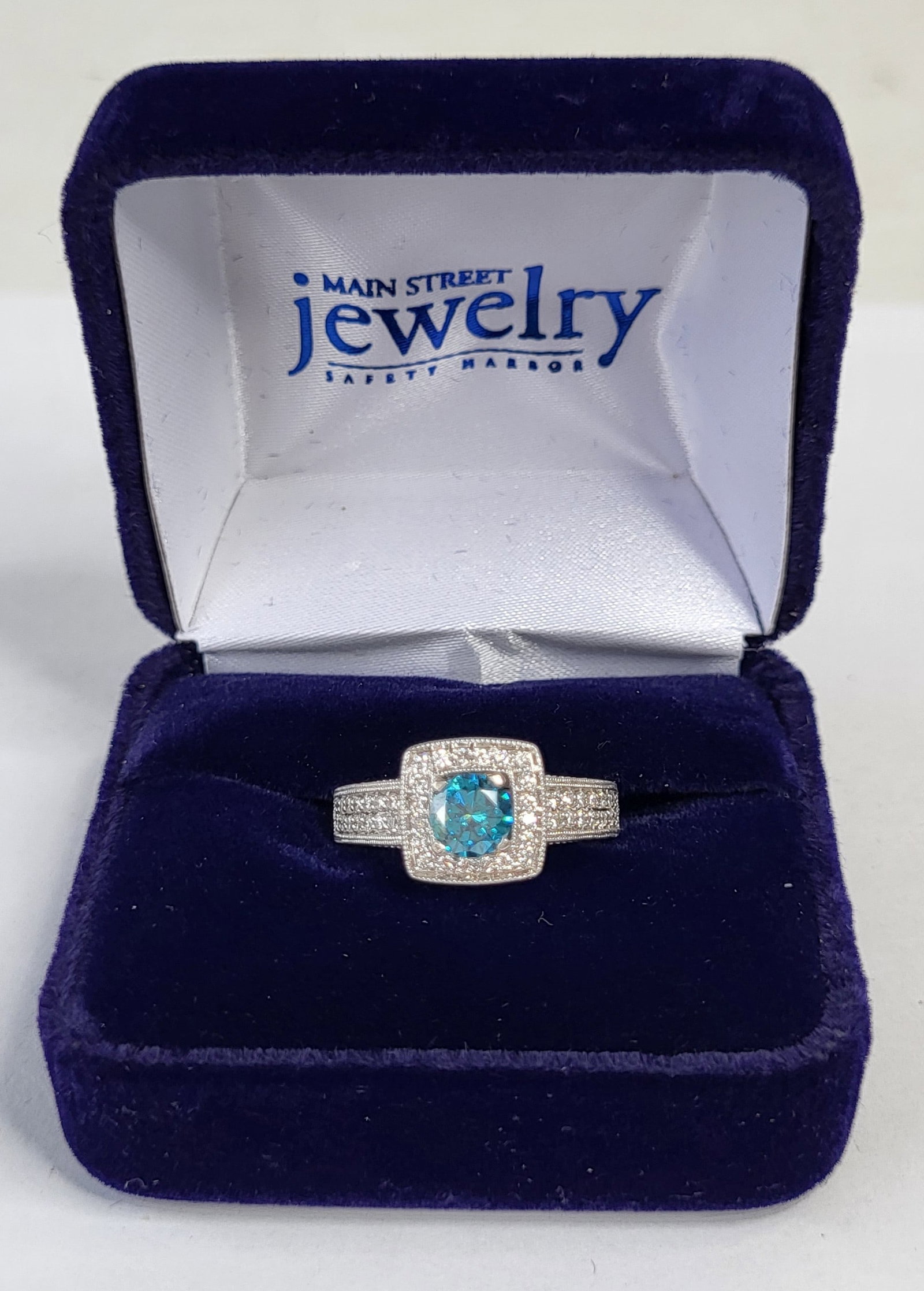 Stylish Irradiated Blue Diamond Set In 14K White Gold With Diamond Melee Aprx 0.60ct 5.6 Tg 3.6 Tdwt: Stylish Irradiated Blue Diamond Set In 14K White Gold With Diamond Melee Aprx 0.60ct 5.6 Tg 3.6 Tdwt Aprx Size 7, interior of ring marked OG 14K Z India, note this is a gorgeous ring, it is beyond our