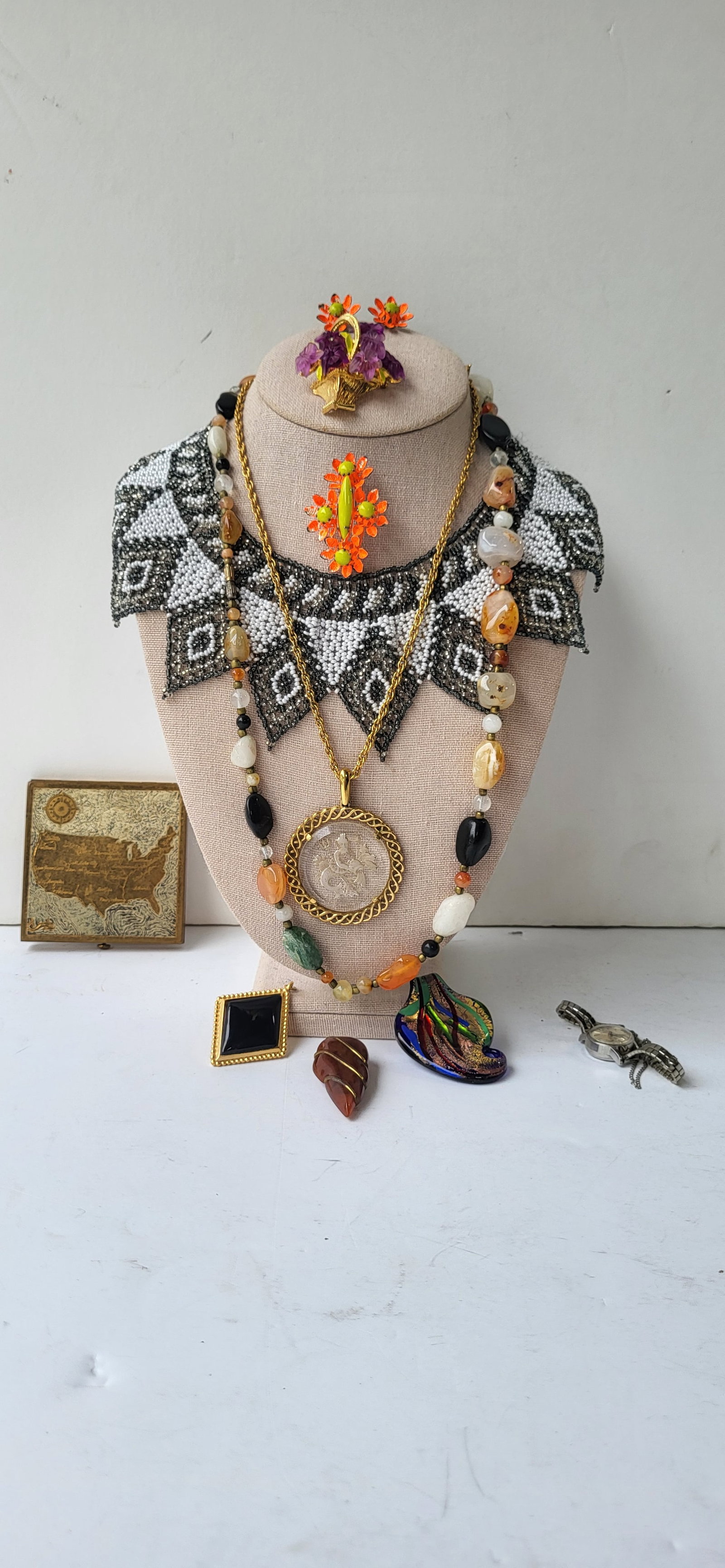 Estate Dozen Piece Dresser Lot Costume Jewelry Compact And Watch: Estate Dozen Piece Dresser Lot Costume Jewelry Compact And Watch. Features vintage hardstone quartz type bead necklace, art deco or revival style beaded choker necklace, neptune pendant on gold plated