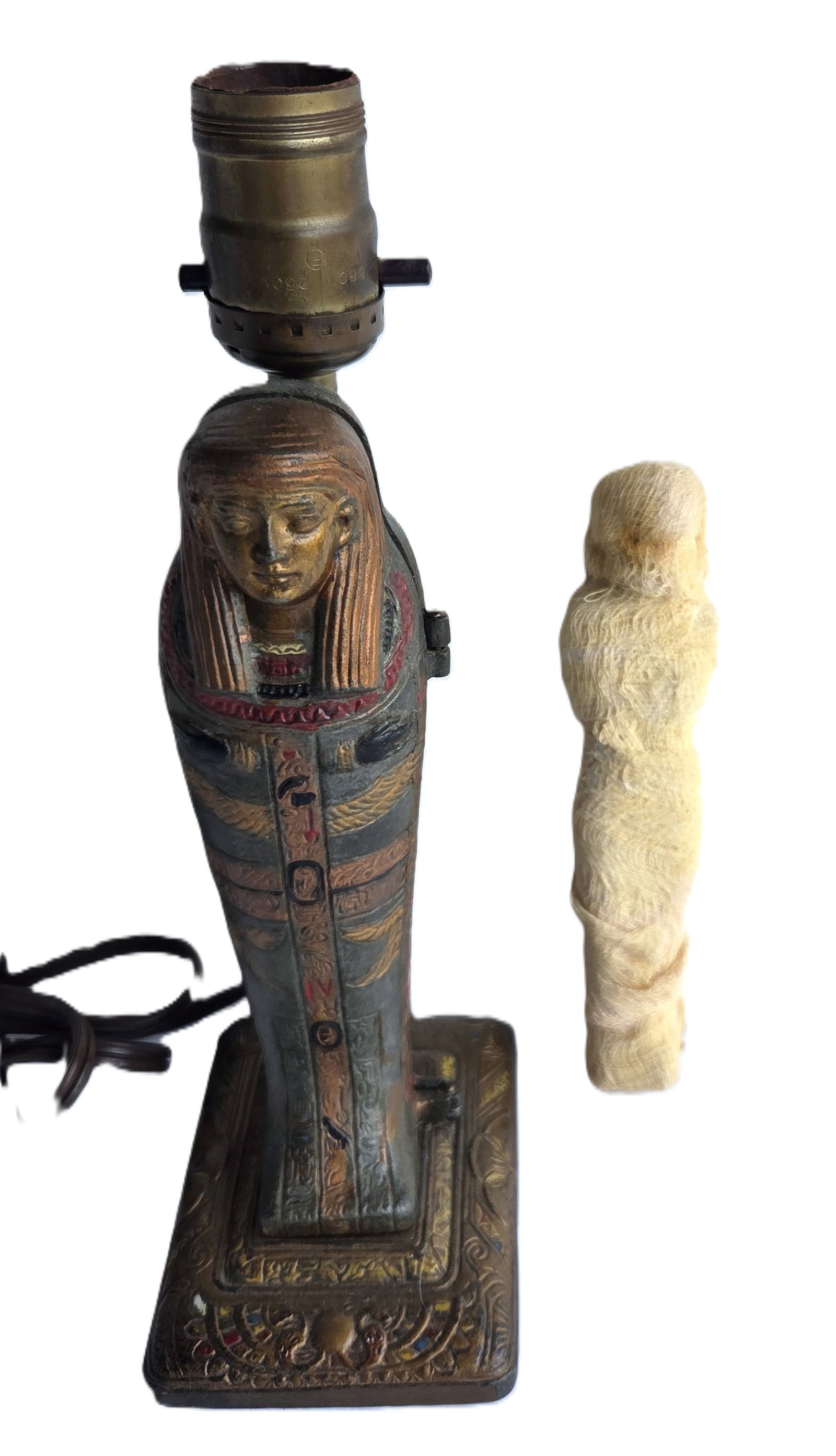 Wild Vintage Art Deco Egyptian Revival Sarcophagus Lamp with Internal Wrapped Mummy: Wild Vintage Art Deco Egyptian Revival Sarcophagus Lamp with Internal Wrapped Mummy. Polychrome white metal. Measures 3.5 X 4.5 inches and 10.5 inches tall. Provenance: Property of a Florida Gulf Coas