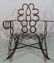 Folk art metal rocker made of black horse shoes